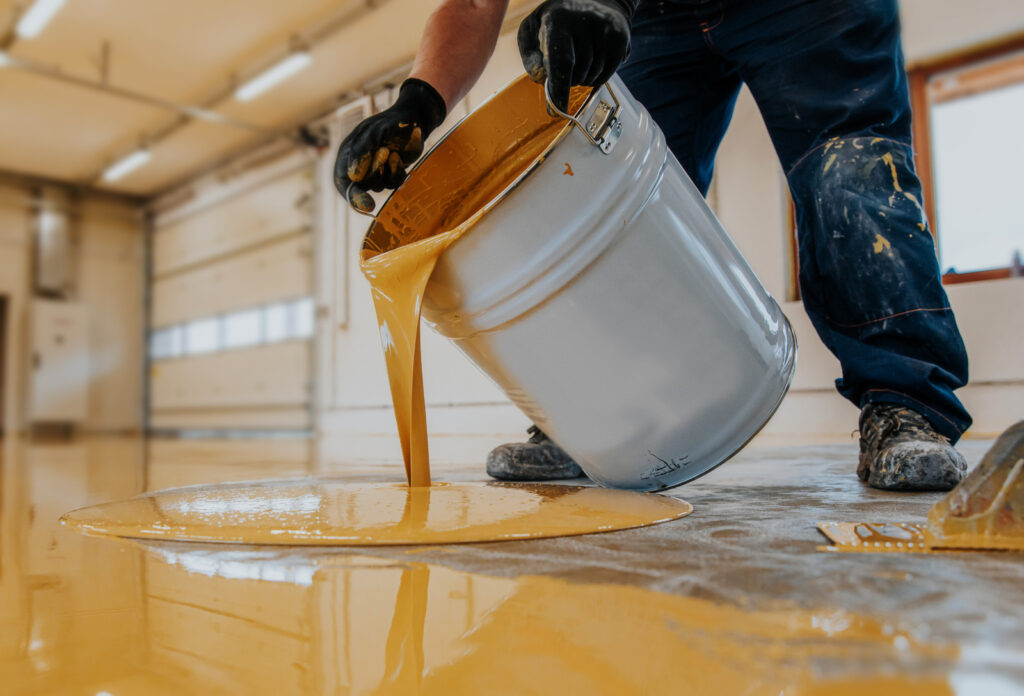 worker applying epoxy flooring in Vancouver