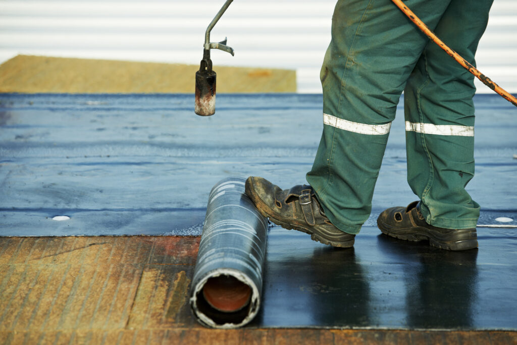 a man repairing flat roof in Vancouver